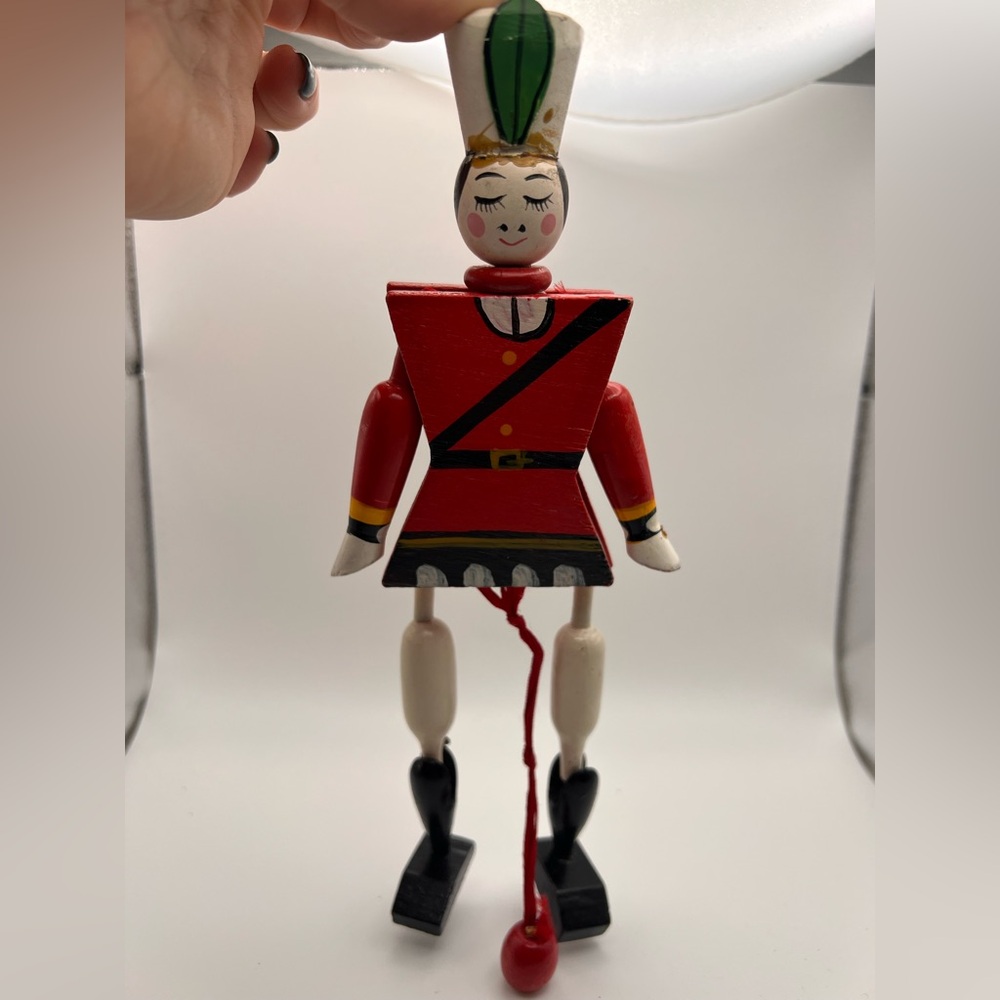Vintage toy soldier pull string ornament.